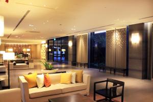 a living room with a white couch and yellow pillows at Grand View Resort Beitou in Taipei