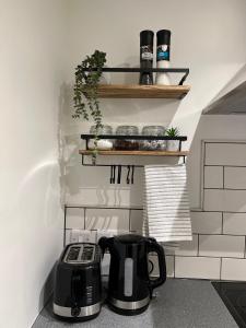 a kitchen with a toaster and a tea kettle on a counter at Ground floor apartment, central location with free parking in Hereford