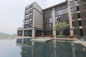 a building with a pool of water in front of it at Grand View Resort Beitou in Taipei