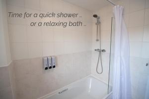 a bathroom with a shower with a shower curtain at Town House Chantry - With Self Check In and Free Parking - Rooms at ipswichdigs in Ipswich