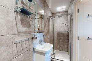 a bathroom with a sink and a shower at Crabbers' Wharf in Portland