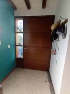 a kitchen with a refrigerator and a wooden door at La Josefina. in Maipú