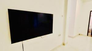 a flat screen tv hanging on a white wall at Hotel SunSet 