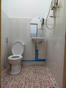 a bathroom with a toilet and a sink and a mirror at The Purple House in Siem Reap