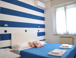 Postel nebo postele na pokoji v ubytování Hotel Susy - Ambienti rinnovati - direttamente su viale Dante e a due passi dal mare