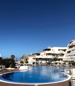 a large swimming pool in front of a hotel at Costa Adeje Modern Studio, close to the beach in Adeje
