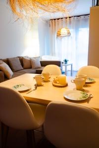 a dining room table with chairs and a couch at Apartamentos Costa Norte in San Vicente de la Barquera