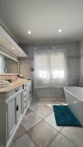 a bathroom with a tub and a sink and a bath tub at Espectacular Bajo Lirio in Calpe +22 photos