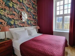 a bedroom with a bed with a red blanket at Classic Apartments in Old Town in Tallinn