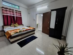 a bedroom with a bed and a sliding door at Purabi's Nest in Tezpur