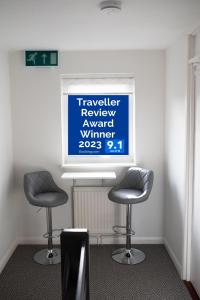 two chairs in a room with a sign on the wall at Town House Chantry - With Self Check In and Free Parking - Rooms at ipswichdigs in Ipswich