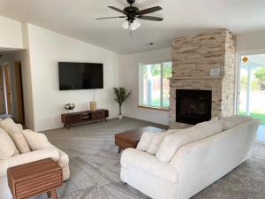 a living room with two white couches and a fireplace at Hot Tub! King Bed-firepitt-near Airport& Freeway in Medford