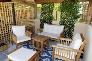 a patio with two chairs and a table and benches at Le Cocon de Lily in Saint-Savin-de-Blay