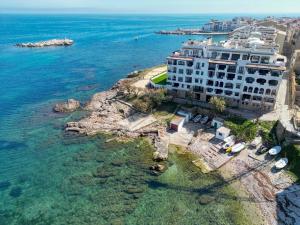 an aerial view of a building on the water at Lola in L'Escala