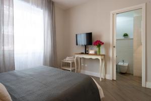 a bedroom with a bed and a television on a table at Dream Holiday Home in Rome