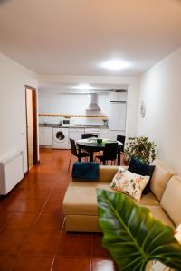 a living room with a couch and a table at Apartamentos Costa Norte in San Vicente de la Barquera