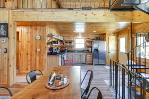 a kitchen and dining room with a table and chairs at Riverfront Rumney Vacation Rental with Fire Pit! in Rumney