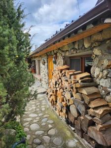 a pile of wood on the side of a building at Guest House Rila in Govedartsi