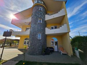 un bâtiment avec une tour dotée d'une horloge. dans l'établissement Apartments San, à Sukošan