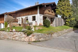 a house with a stone wall in front of it at Lackner in Teisendorf