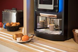 a microwave oven with a plate of eggs and bread at ACE Hôtel Metz in Metz