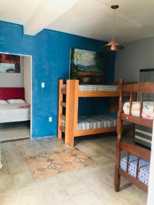a room with two bunk beds and a blue wall at Apart Fraga Maia in Feira de Santana