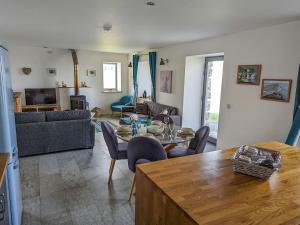 a living room with a table and chairs and a couch at The Beach House in Dunvegan