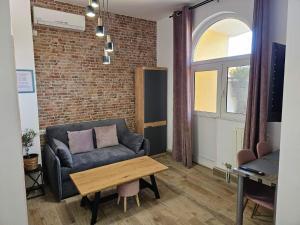 a living room with a couch and a table at Apartments San in Sukošan