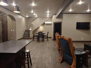 a large room with tables and chairs and a tv at The Bunkhouse in Priest River