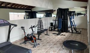 a gym with bikes and exercise equipment in a room at Hotel Portal das Águas in Jaguariúna