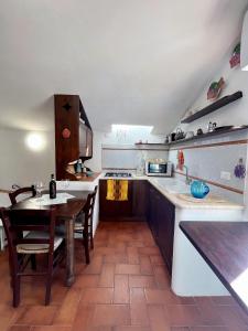 a kitchen with a table and a dining room at Divina Casa Vacanze Donna Silvana in Sperlonga +11 photos
