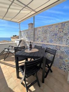 斯佩隆加的住宿－Divina Casa Vacanze Donna Silvana，露台设有桌椅和瓷砖墙