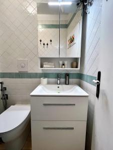 a bathroom with a white sink and a toilet at Divina Casa Vacanze Donna Silvana in Sperlonga