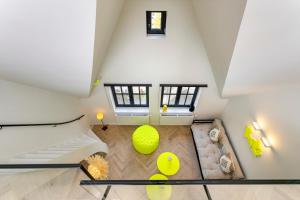 a attic room with a large yellow ball on the floor at Vrijdagmarkt by Lit d’Art in Antwerp