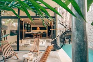 a hammock in the living room of a house at Round Villa Private Pool & Jungle rooftop 2A in Tulum