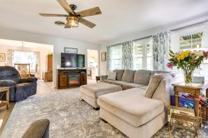 a living room with a couch and a tv at Mount Dora Vacation Rental Steps to Lake Gertrude in Mount Dora