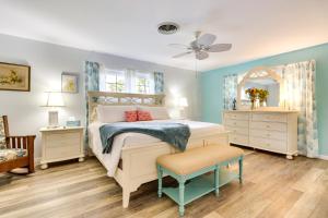 a bedroom with a bed and a ceiling fan at Walk to Lakes! Tropical Escape in Mount Dora in Mount Dora