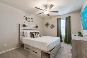 a bedroom with a bed and a ceiling fan at New Construction 3BR Home Near Chattahoochee River in Norcross