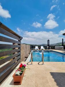 een patio met een zwembad en bloemen in een pot bij Savannah suite in ‘Isfiyā