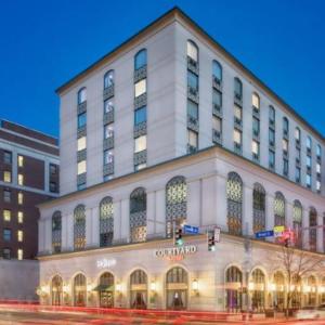 a large white building on the corner of a street at Courtyard by Marriott Stamford Downtown in Stamford