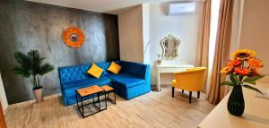 a living room with a blue couch and a table at Summer Love in Mangalia