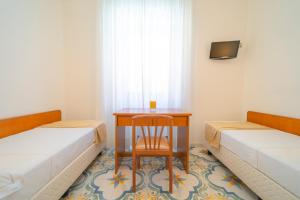 Łóżko lub łóżka w pokoju w obiekcie Hotel San Pietro