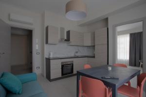 a kitchen with a blue table and a blue couch at areacafè affitta camere in Canicattì