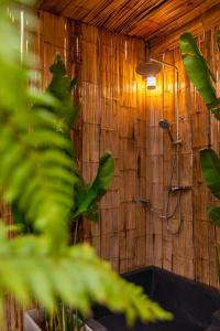 a bathroom with a shower in a wooden wall at Sky Pruek Cumulus in Mon Jam