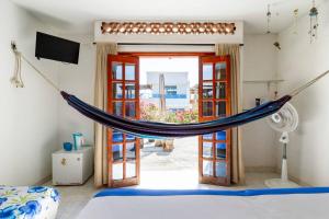 a hammock hanging in a room with a window at Casa Tara in Taganga
