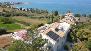an aerial view of a house with solar panels on the roof at Pomos Harbourbiew Villa in Pomos