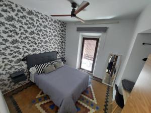 a bedroom with a bed and a stone wall at apartamentos fuente nueva sande in Cáceres