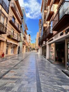 an empty street in a city with buildings at Hotel Las Tablas in Daimiel