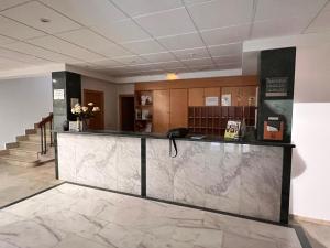 a lobby with a reception counter in a building at Hotel Las Tablas in Daimiel