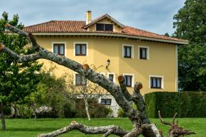 a tree branch in front of a house at Hotel Hontoria in Hontoria